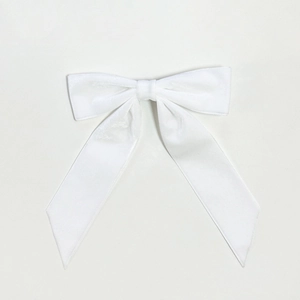 Macro shot of white velvet bow hair clip with satin texture and elegant French design