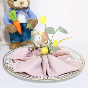Easter egg floral napkin ring with yellow forsythia and berries on a purple napkin