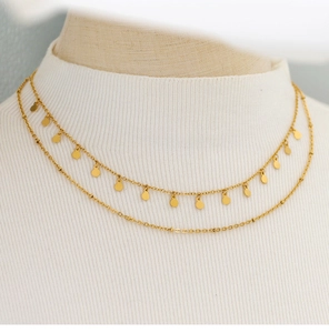 Close-up of double-layer 18K gold plated necklace on white turtleneck sweater