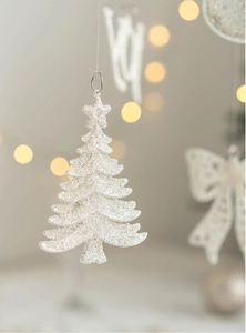 Macro view of white glitter Christmas tree ornament with a silver hanging loop
