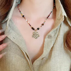 Ethnic resin crystal beaded necklace with vintage hammered gold flower pendant detail
