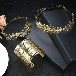 Detail of golden leaf bridal headband and multi-layer metallic wire bracelet set