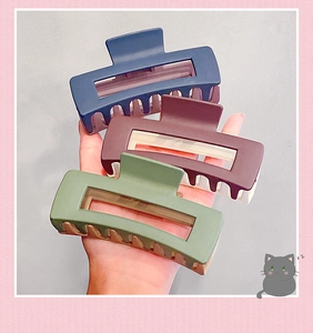 Three large matte hair claws in navy blue, burgundy, and green for thick hair styling