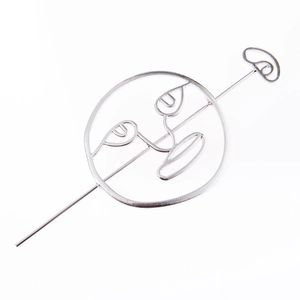 Minimalist silver alloy hair stick featuring an abstract hollow face design in a circle