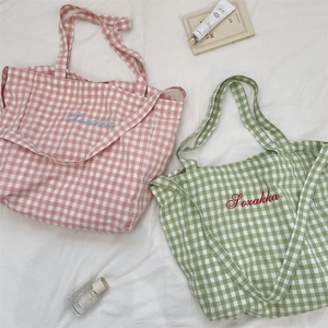 Detail of Gingham tote bags showing Sozakka embroidery and textured cotton linen fabric