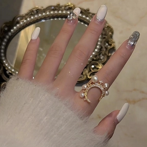 Elegant adjustable star and moon gold ring with pearls and cubic zirconia on model finger