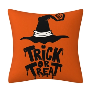 Detail of orange linen Halloween pillowcase with black Trick or Treat text and wizard hat