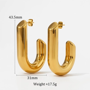 Macro view of gold J-shaped geometric chunky earrings with size and weight metrics