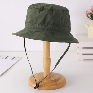 Quick-dry outdoor sun hat in army green with adjustable windproof cord on wooden stand