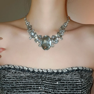 Close-up of a luxury silver teardrop rhinestone necklace with large crystal pendants