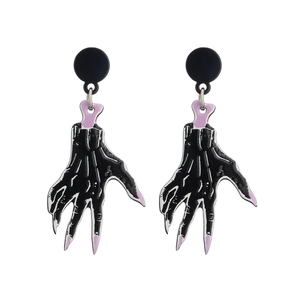 Gothic Halloween earrings featuring black hand designs with purple nails and bones on white backdrop