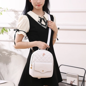 White quilted backpack with floral rose embroidery and adjustable straps for women