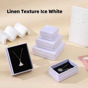 Detail of ice white Leny pattern jewelry boxes with black velvet lining on display