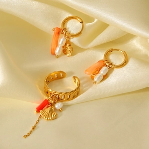 Luxurious gold stainless steel jewelry set with coral beads and pearls on silk