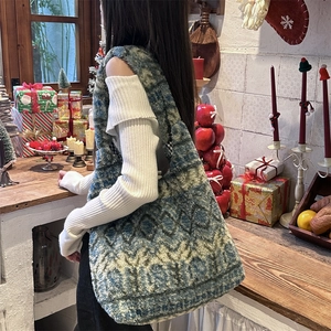 Detailed texture of blue and green geometric plush tote bag in a cozy Christmas scene