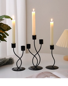 Minimalist matte black wrought iron candle holders in single, double, and triple head designs