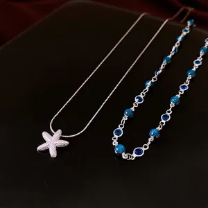 Collier double couche avec pendentif étoile de mer en zircon et perles bleu profond
