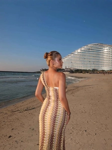 Elegant lace one-shoulder slim fit beach dress with wave patterns for women on a sunset shore
