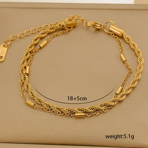 Close-up of double-layer gold stainless steel chain with twist and tube details