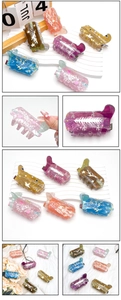 Detail of colorful acrylic boot hair claws with star and Christmas tree patterns