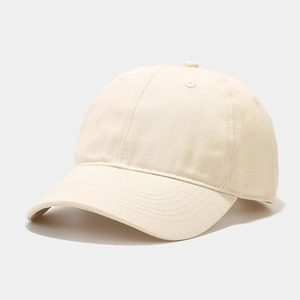 Detailed macro view of the cream cotton twill fabric and stitching on a baseball cap