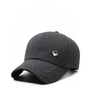 Detail of dark gray baseball cap showing twill fabric texture and embossed fashion logo
