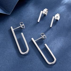 Detailed view of 925 sterling silver geometric stud earrings with engraved S925 hallmark