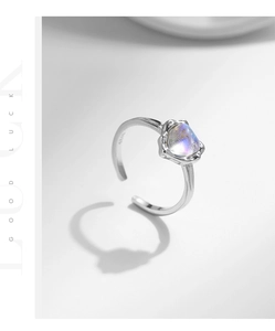 Macro shot of S925 sterling silver ring with heart-shaped moonstone and irregular bezel