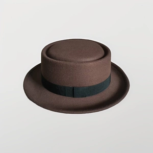 Classic brown pork pie hat with a wide black ribbon band and flat brim for fashion