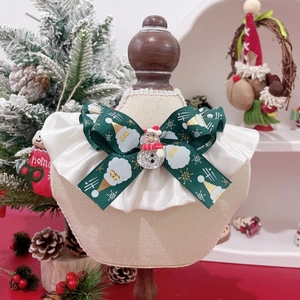 Christmas pet collar with green bow and snowman charm on a beige mannequin