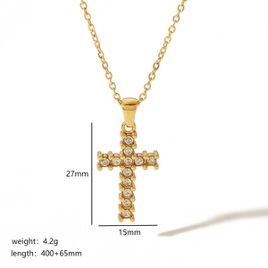 Detail of 18k gold cross necklace with 27mm pendant dimensions and chain length specs