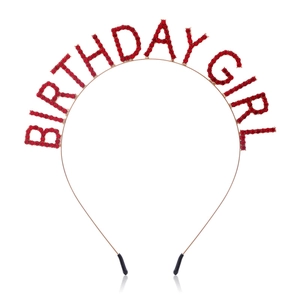 Detail of golden metal headband with Birthday Girl red rhinestone lettering for parties