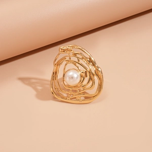 Macro shot of gold irregular spiral open ring with a central white imitation pearl