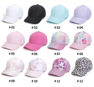 Grid view of 12 multi-colored baseball caps with floral, tie-dye and leopard prints