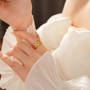 Dettaglio dell'anello floreale placcato oro 18k con zirconi rossi e bianchi al dito
