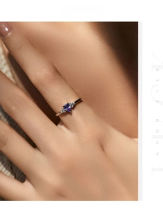Macro shot of s925 silver ring featuring purple heart-shaped stone on model's finger