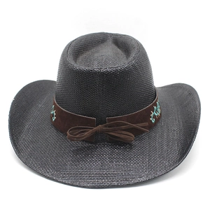 Detail view of woven black cowboy hat with brown suede band and turquoise embroidery