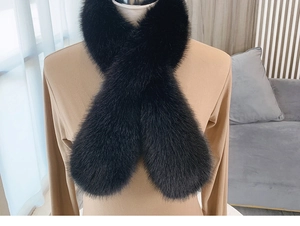 Detail of fluffy black faux fur scarf crossed over a jacket for cozy winter styling