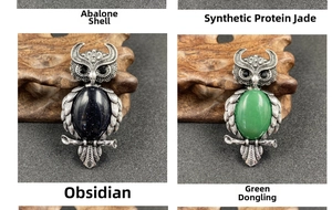 Macro view of vintage owl pendants with natural abalone shell and gemstones