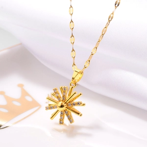 Detail of rose gold sunflower necklace with faux diamonds on a crown ceramic tray