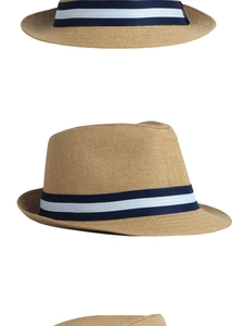Detail view of woven straw fedora hat featuring a stylish blue and white striped ribbon