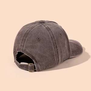 Detail of vintage washed baseball cap showing metal buckle and reinforced stitching