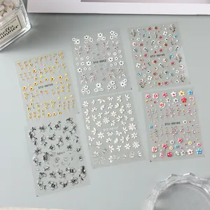 Detailed 5D embossed nail stickers featuring white and yellow daisies with texture