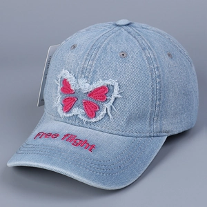 Detailed pink butterfly embroidery and Free Flight lettering on blue denim baseball cap