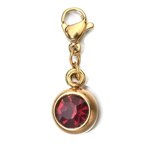 Macro shot of a 6mm red zircon pendant with gold plated lobster clasp for jewelry making