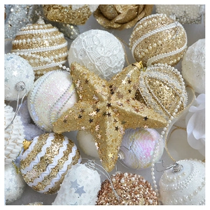 Macro shot of champagne gold glitter Christmas ornaments with pearls and sequins