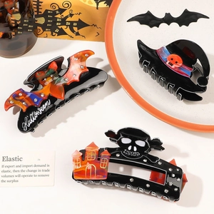 Set of three Halloween acrylic hair claws with bat, witch hat, and skull designs with rhinestones