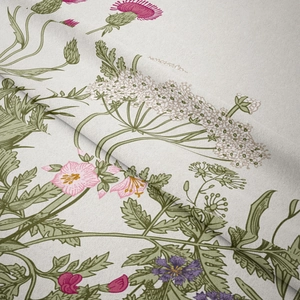 Detail of bohemian tapestry fabric showing delicate pink wildflowers and linen texture