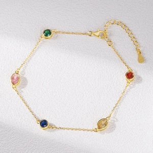 S925 sterling silver gold bracelet with five colorful oval zircon gemstones on white background