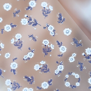 Minimalist white flower and navy leaf nail stickers with flexible adhesive backing